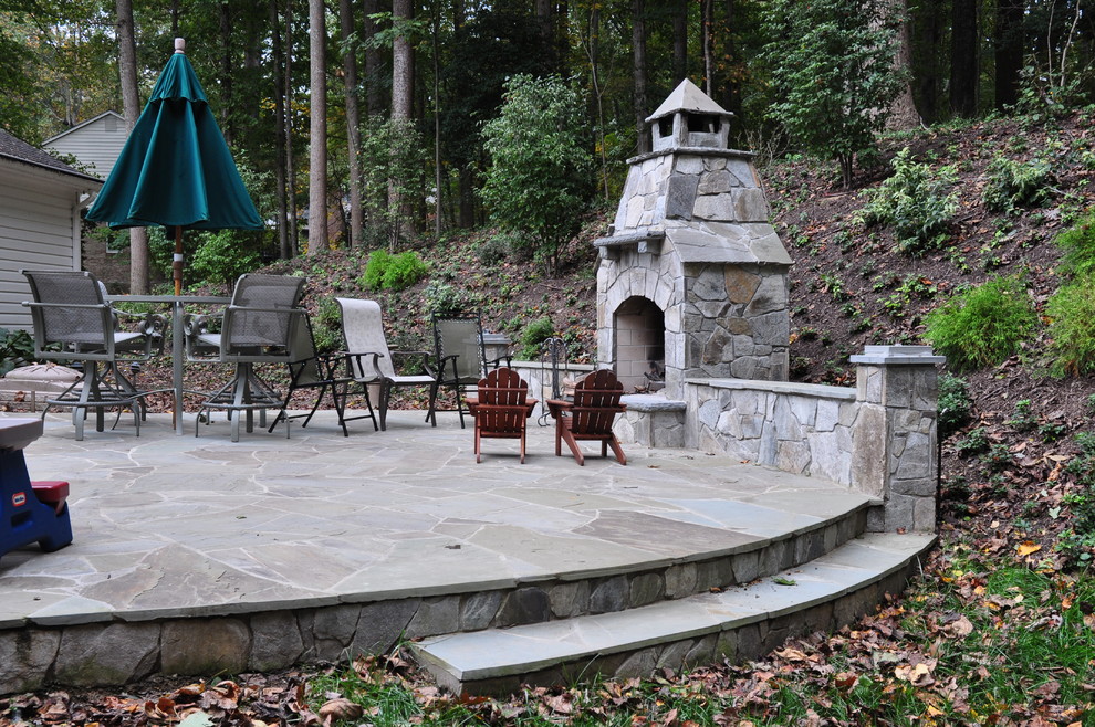Design ideas for a large traditional backyard patio in DC Metro with a fire feature, natural stone pavers and no cover.