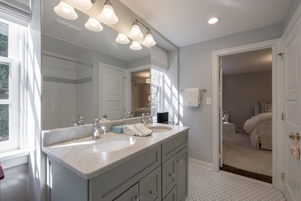 Inspiration for a mid-sized contemporary kids bathroom in Philadelphia with flat-panel cabinets, white cabinets, a shower/bathtub combo, white tile, ceramic tile, grey walls, ceramic floors, an undermount sink and marble benchtops.