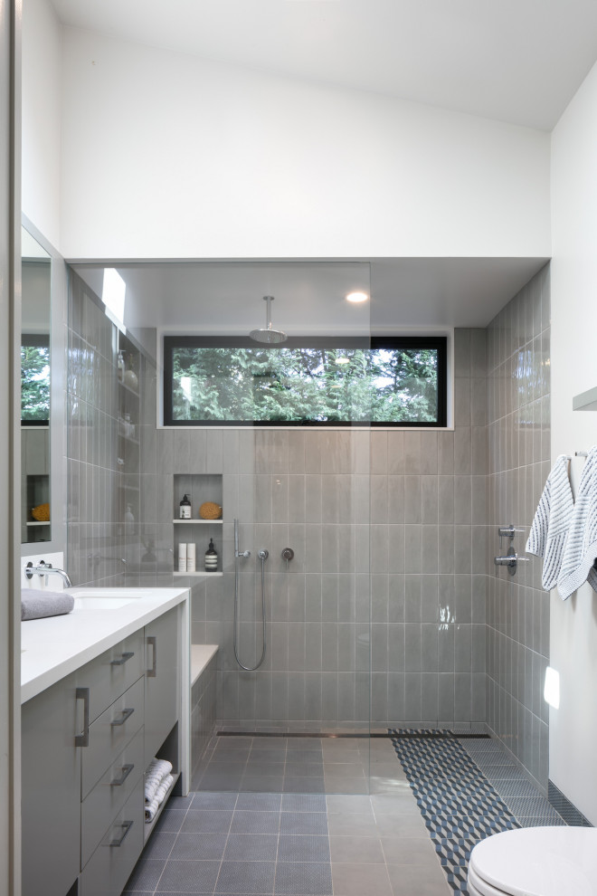 Design ideas for a contemporary bathroom in Los Angeles with flat-panel cabinets, grey cabinets, a curbless shower, gray tile, white walls, an undermount sink, grey floor, an open shower and white benchtops.