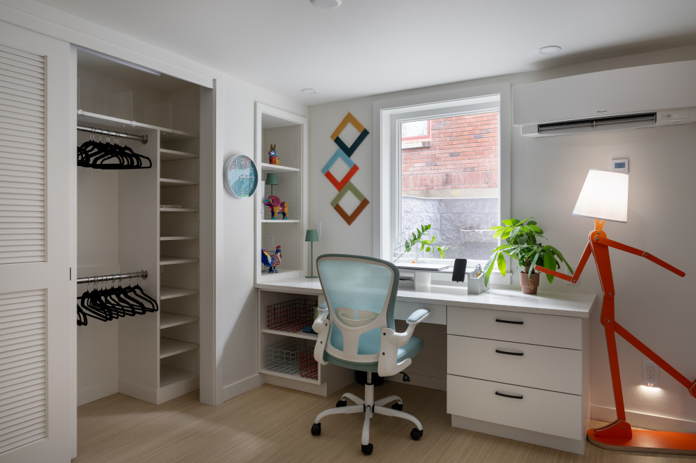 Inspiration for a small transitional gender-neutral beige floor dressing room remodel in Seattle with flat-panel cabinets and white cabinets