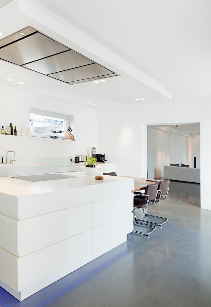 This is an example of a modern eat-in kitchen in Cologne with flat-panel cabinets, white cabinets, white splashback, glass sheet splashback and with island.