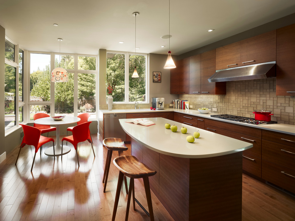 Design ideas for a contemporary l-shaped eat-in kitchen in New York with flat-panel cabinets, dark wood cabinets, grey splashback, stainless steel appliances, medium hardwood floors and with island.