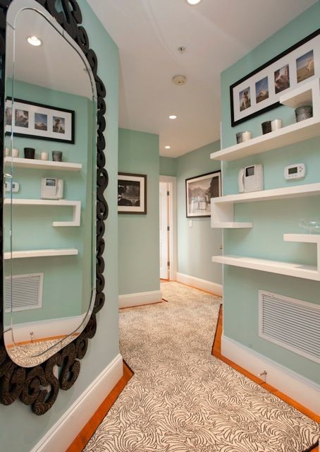 This is an example of a small arts and crafts entryway in Boston with a single front door, green walls and carpet.