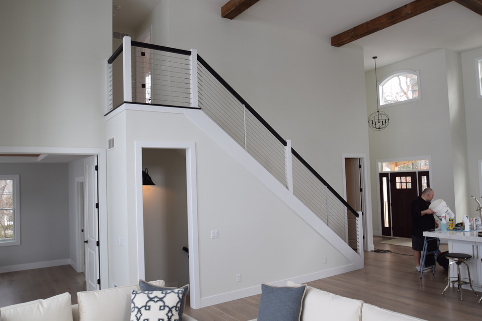 Mid-sized contemporary carpeted straight staircase in Other with carpet risers.