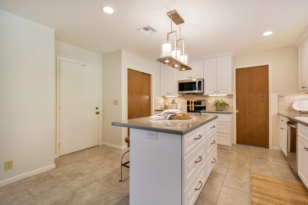 Inspiration for a large transitional l-shaped porcelain tile open concept kitchen remodel in Phoenix with an undermount sink, raised-panel cabinets, white cabinets, quartz countertops, beige backsplash, porcelain backsplash, stainless steel appliances and an island