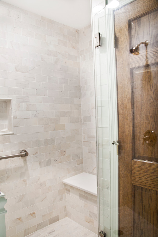 This is an example of a traditional bathroom in Milwaukee with shaker cabinets, white cabinets, an alcove tub, an alcove shower, a two-piece toilet, white tile, ceramic tile, blue walls, marble floors and an undermount sink.