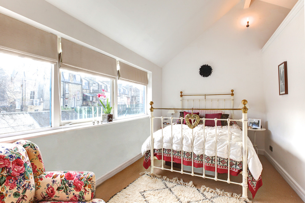 Photo of a mid-sized eclectic bedroom in London.