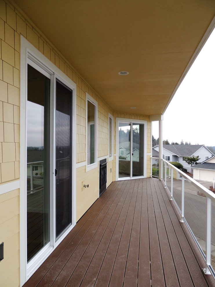 Inspiration for a small transitional deck remodel in Seattle with a roof extension