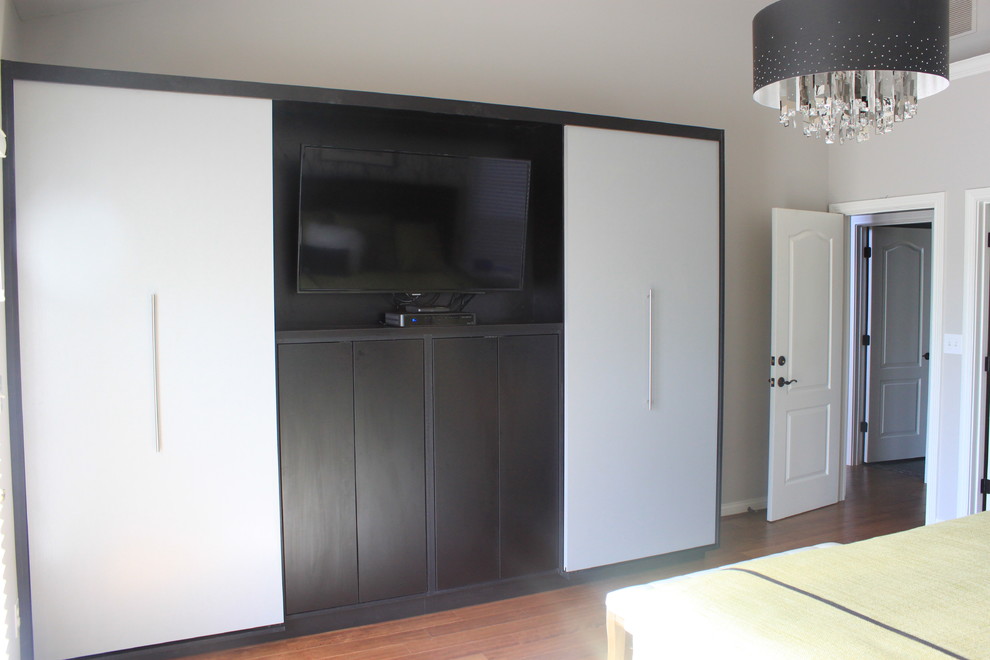 Photo of a large contemporary master bedroom in Cincinnati with grey walls, medium hardwood floors and no fireplace.