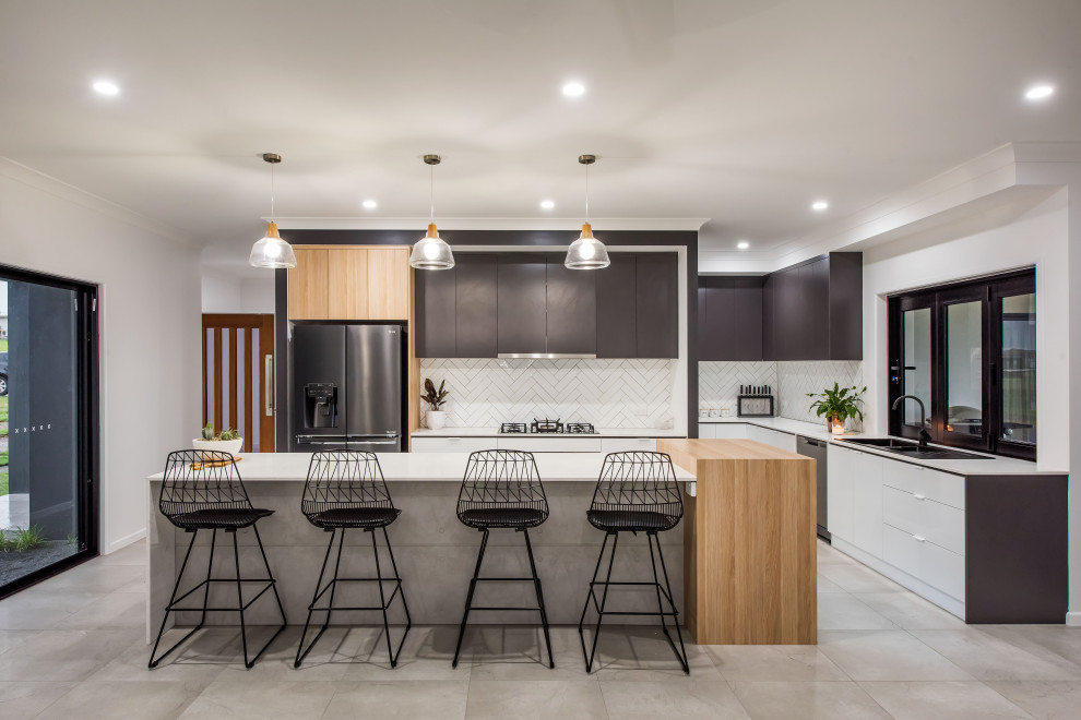 Inspiration for a large contemporary galley kitchen pantry in Other with a drop-in sink, flat-panel cabinets, white cabinets, granite benchtops, white splashback, subway tile splashback, black appliances, ceramic floors, with island, grey floor and white benchtop.