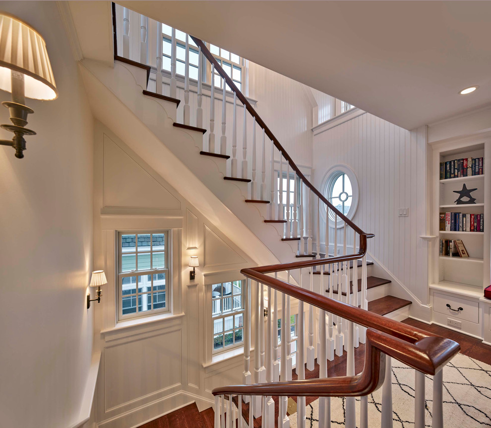 Photo of a mid-sized beach style hallway in Philadelphia with white walls, medium hardwood floors and brown floor.