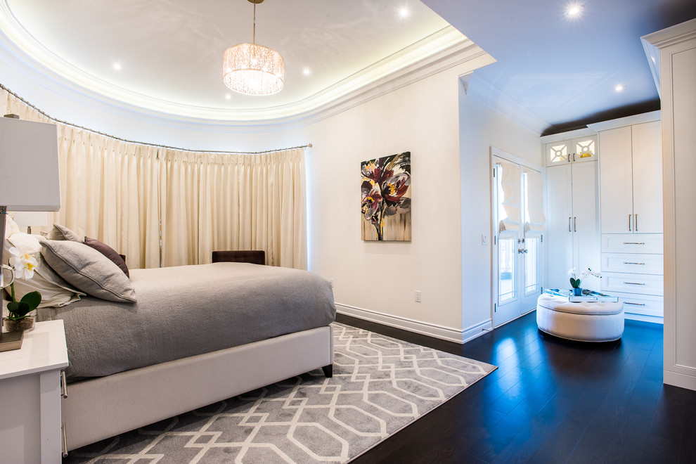 Photo of a large contemporary master bedroom in Toronto with beige walls, dark hardwood floors, no fireplace and brown floor.