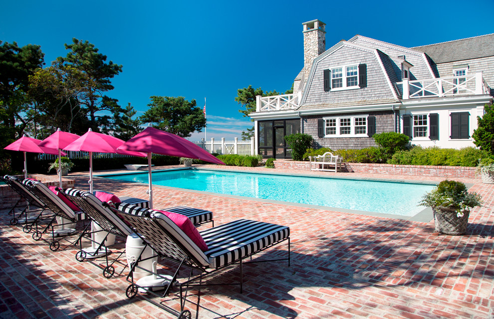 Mid-sized traditional side yard rectangular pool in Boston with a pool house and brick pavers.
