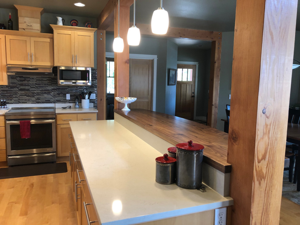 Mid-sized transitional l-shaped medium tone wood floor open concept kitchen photo with an undermount sink, flat-panel cabinets, light wood cabinets, quartz countertops, multicolored backsplash, ceramic backsplash, stainless steel appliances, an island and white countertops