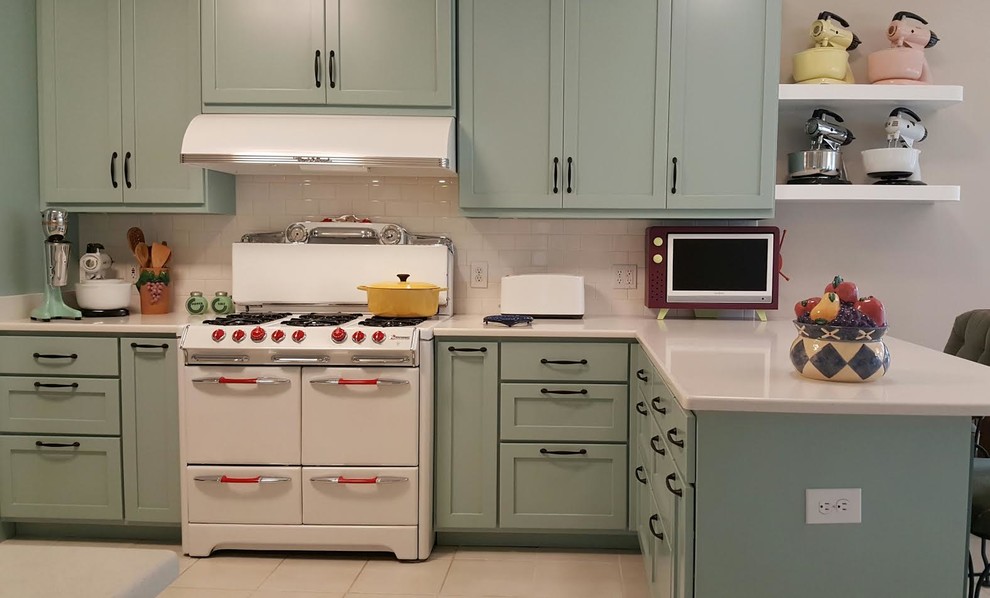 Photo of a mid-sized midcentury eat-in kitchen in Miami with shaker cabinets, blue cabinets, quartzite benchtops, white splashback, subway tile splashback, white appliances, ceramic floors, a peninsula and beige floor.