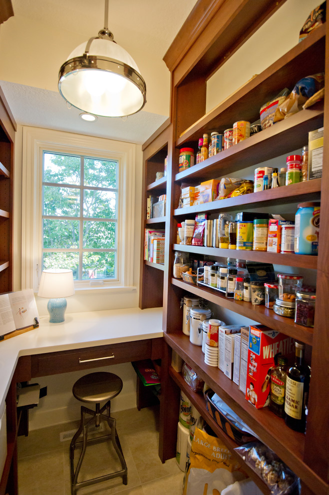 This is an example of a traditional kitchen pantry in Chicago with open cabinets and dark wood cabinets.
