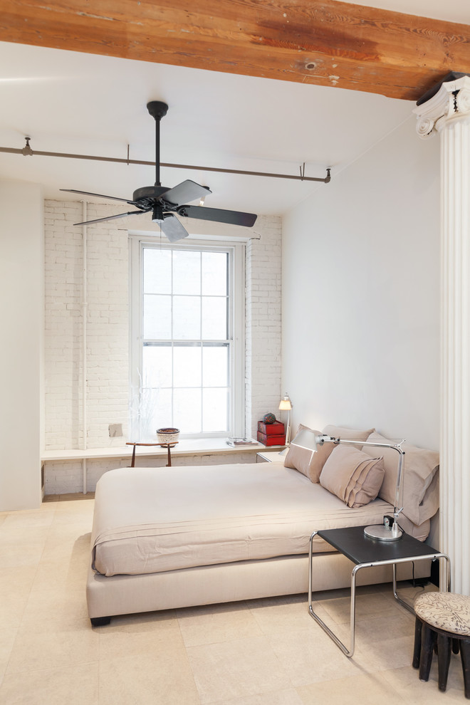 Design ideas for an industrial bedroom in New York with white walls.