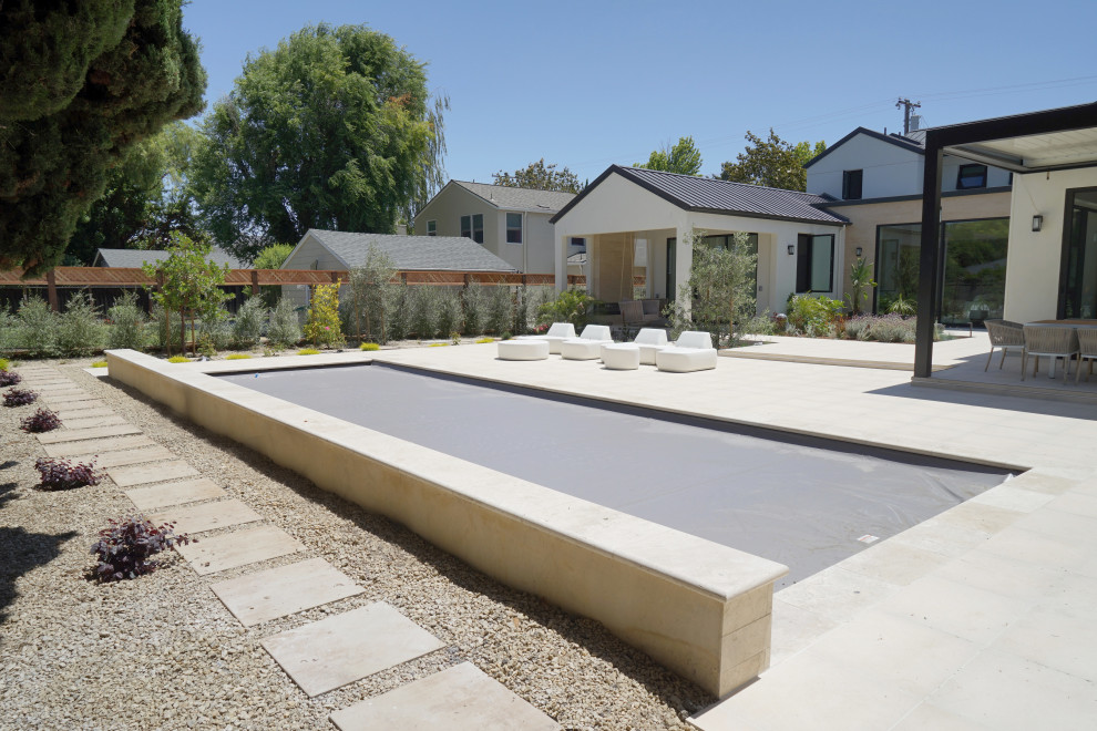 Example of a large trendy backyard gravel and rectangular lap pool landscaping design