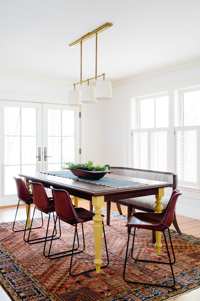 Inspiration for a mid-sized open plan dining in Boston with white walls, medium hardwood floors, no fireplace and brown floor.
