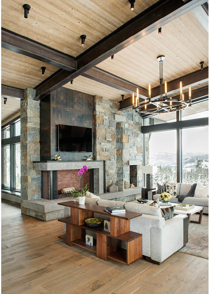 Photo of a large modern formal open concept living room in Other with medium hardwood floors, a corner fireplace, a stone fireplace surround, a wall-mounted tv and brown floor.