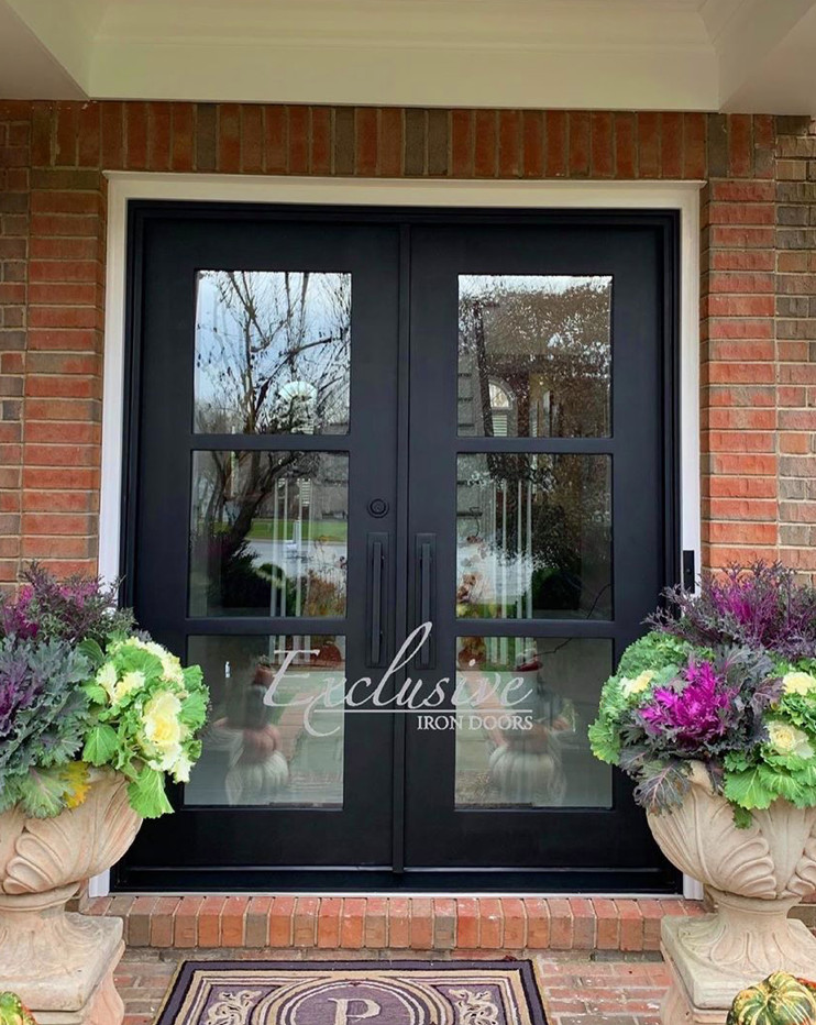 Example of a large transitional front door design in Austin with a black front door