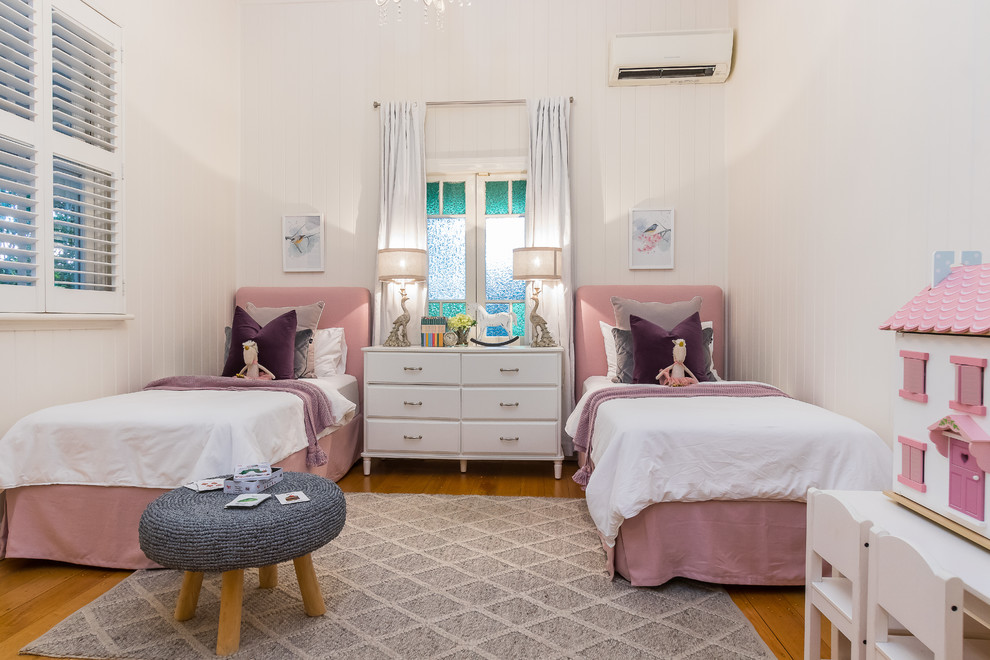Inspiration for a traditional bedroom in Brisbane with white walls, medium hardwood floors and brown floor.