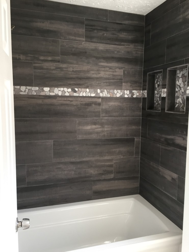 Alcove bathtub - mid-sized transitional gray tile and porcelain tile porcelain tile alcove bathtub idea in Houston with shaker cabinets, white cabinets, a two-piece toilet, gray walls, a vessel sink and granite countertops