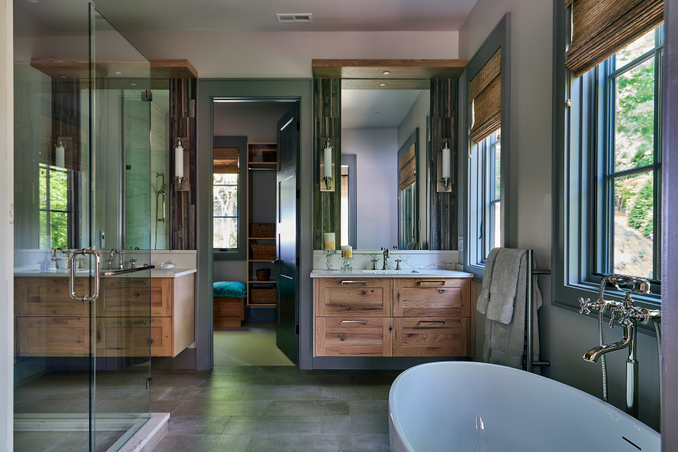 This is an example of a mid-sized transitional master bathroom in Other with recessed-panel cabinets, brown cabinets, a freestanding tub, a corner shower, a one-piece toilet, beige walls, ceramic floors, an undermount sink, granite benchtops, grey floor, a hinged shower door, white benchtops, an enclosed toilet, a double vanity and a built-in vanity.