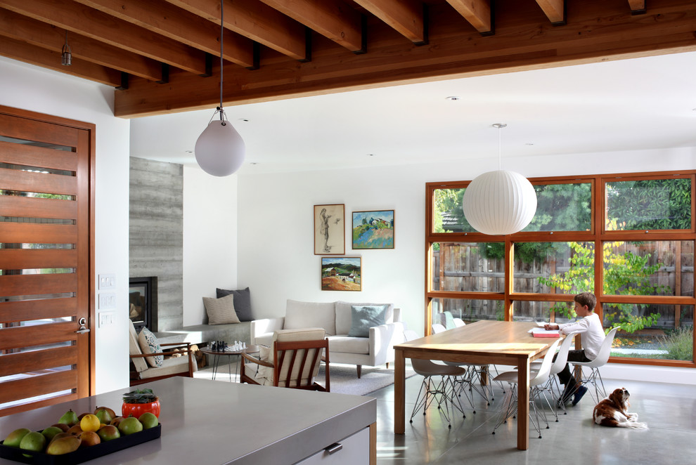 Photo of a contemporary family room in San Francisco with concrete floors.