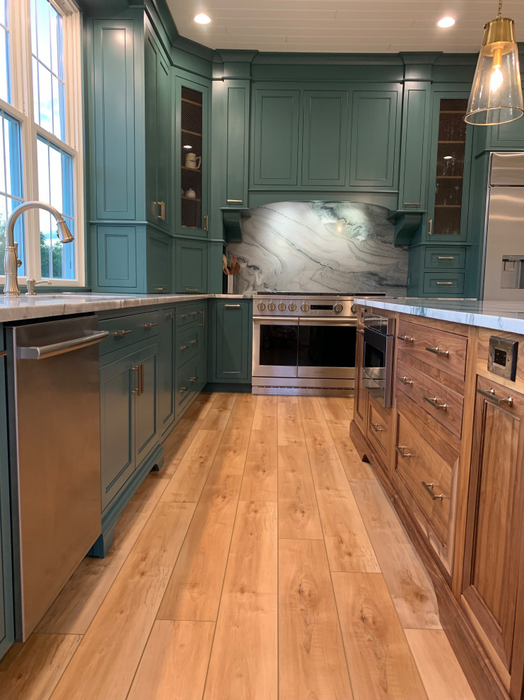 Inspiration for a mid-sized transitional l-shaped separate kitchen in DC Metro with beaded inset cabinets, green cabinets, quartzite benchtops, stainless steel appliances, with island, white benchtop, an undermount sink, light hardwood floors, brown floor and timber.