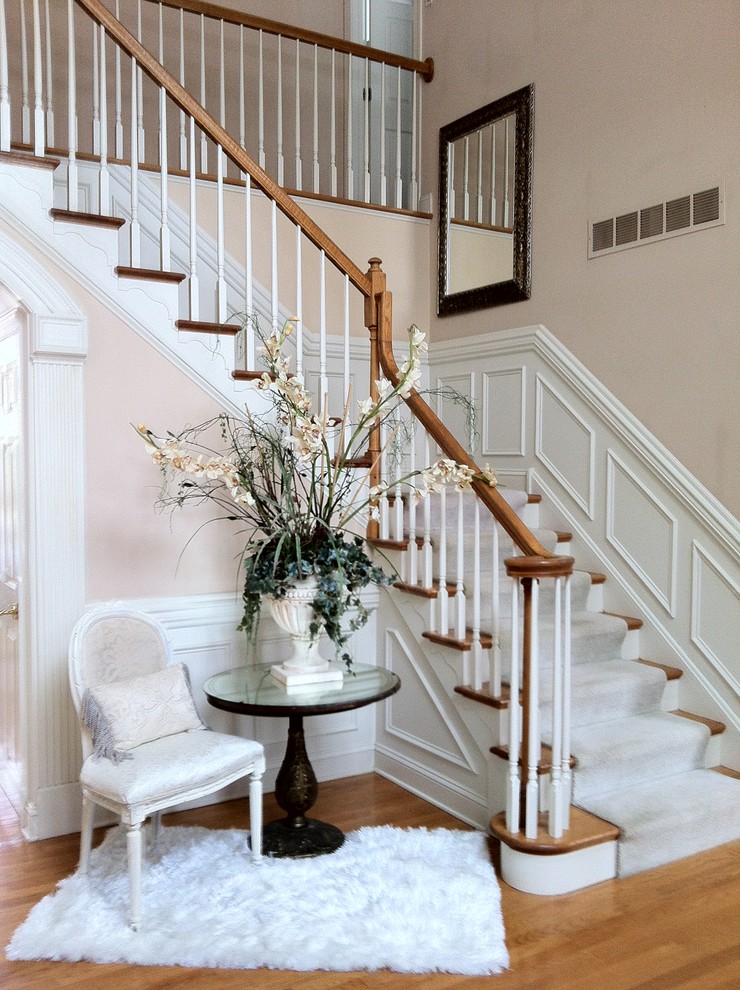 Inspiration for a mid-sized traditional foyer in Philadelphia with pink walls and medium hardwood floors.