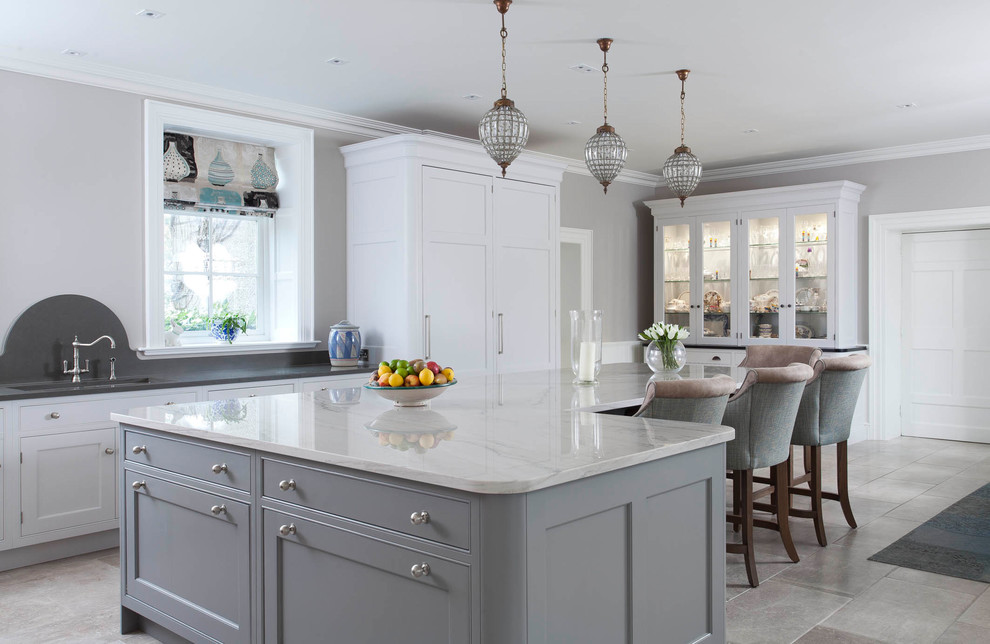 This is an example of an expansive traditional kitchen in Other with shaker cabinets, grey cabinets, marble benchtops, ceramic floors, with island and beige floor.