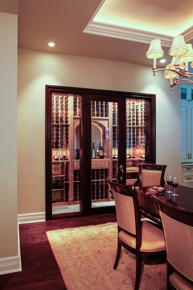 Large transitional wine cellar in Miami with slate floors and display racks.