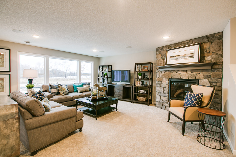 Photo of a large transitional enclosed family room in Minneapolis with beige walls, carpet, a standard fireplace, a stone fireplace surround, a freestanding tv and beige floor.