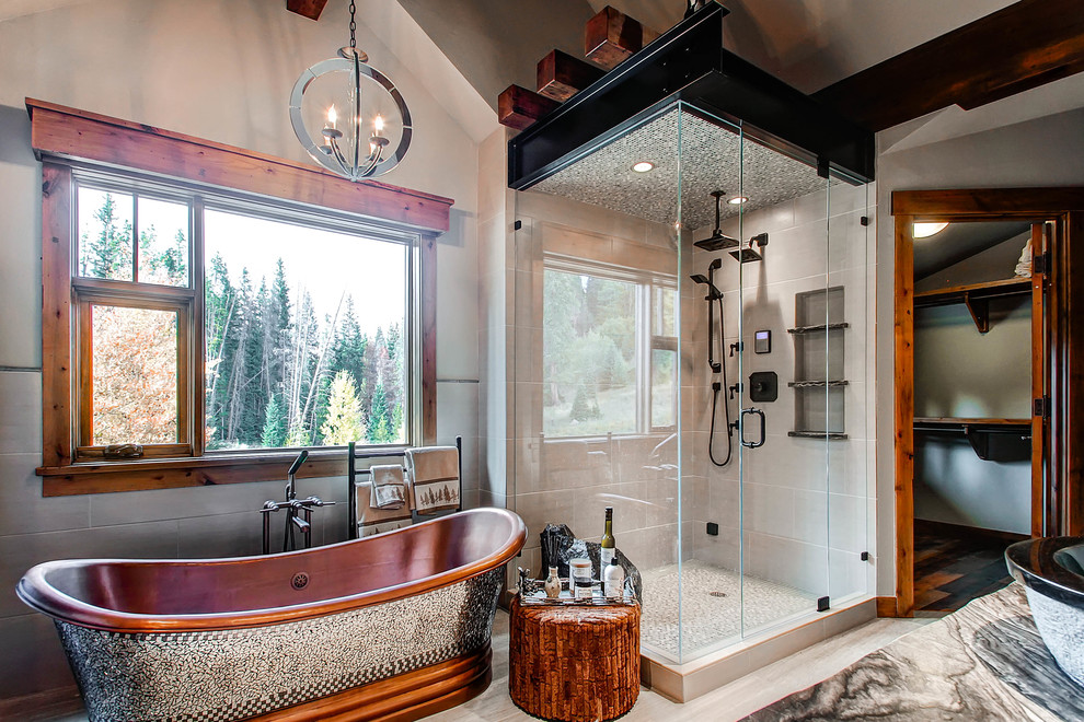 This is an example of a country bathroom in Denver with a freestanding tub and a vessel sink.