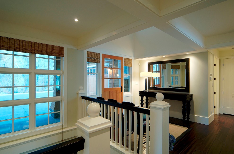 Arts and crafts dark wood floor entryway photo in Vancouver with white walls and a light wood front door