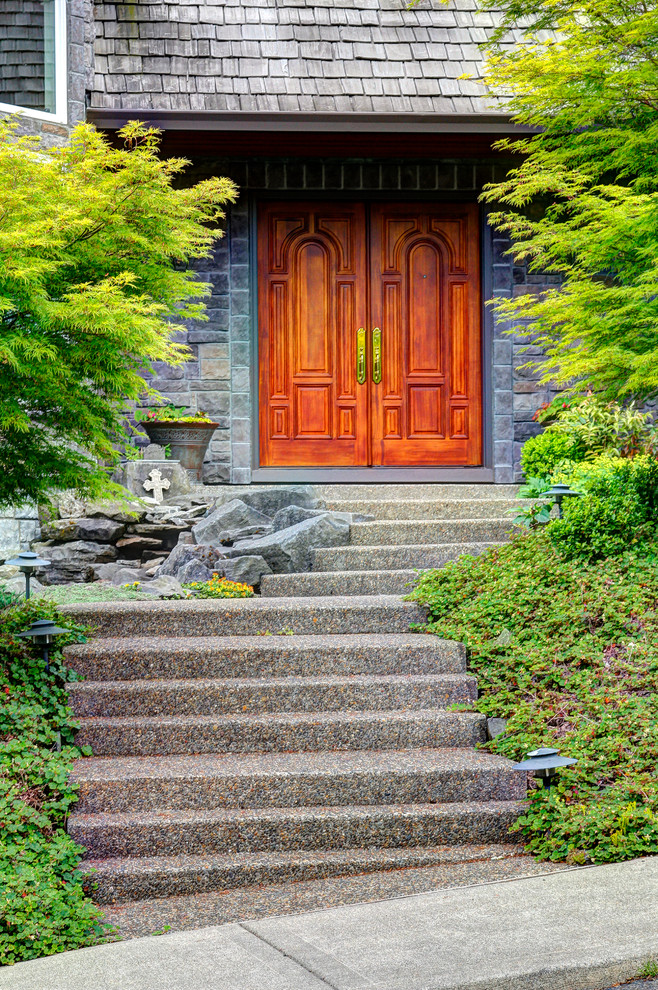 This is an example of a traditional front door in Portland with a double front door and a medium wood front door.
