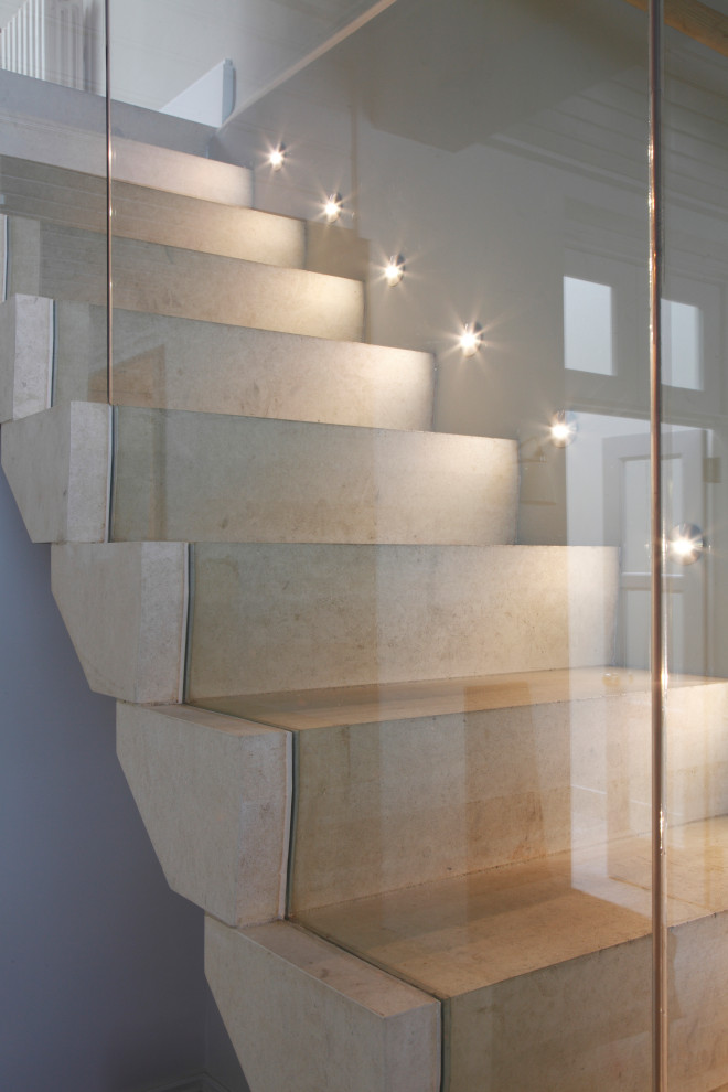 Contemporary limestone straight staircase in Other with limestone risers and glass railing.