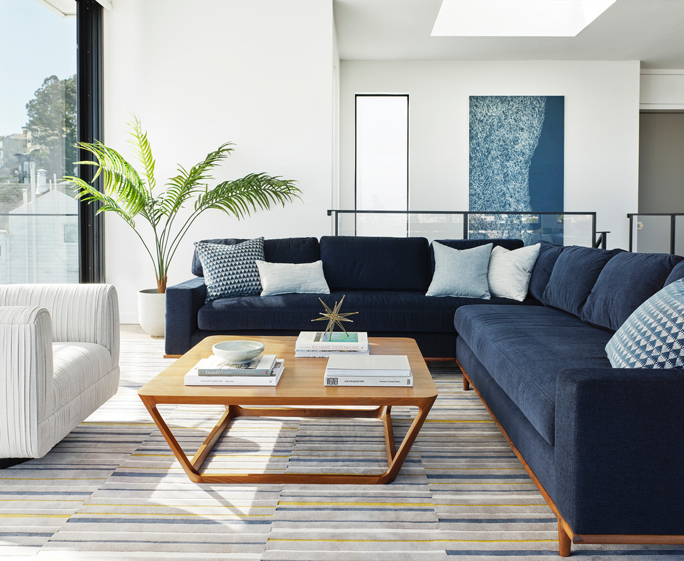 Living room - mid-century modern open concept light wood floor and beige floor living room idea in San Francisco with white walls, no fireplace and no tv
