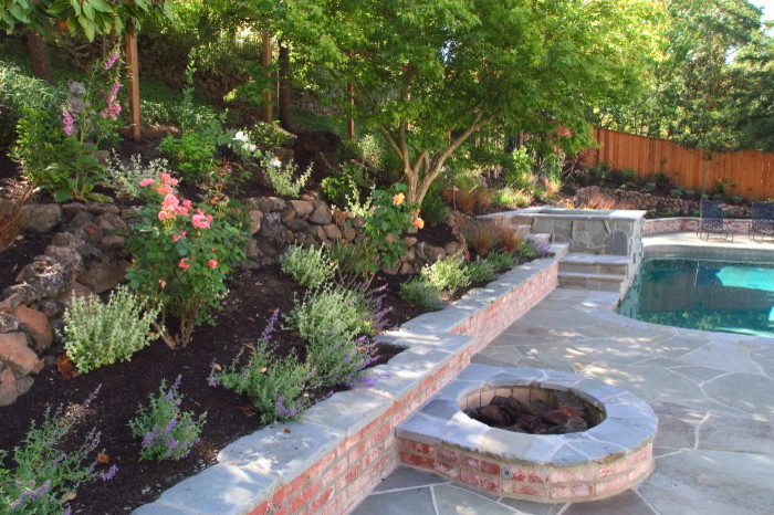 Mid-sized contemporary backyard partial sun garden in San Francisco with a fire feature and natural stone pavers.