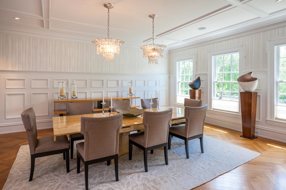 Inspiration for a mid-sized traditional dining room in New York with white walls and medium hardwood floors.