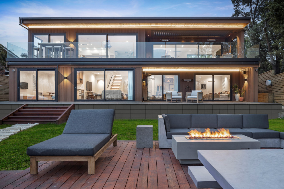Inspiration for an expansive contemporary two-storey house exterior in Auckland with wood siding.