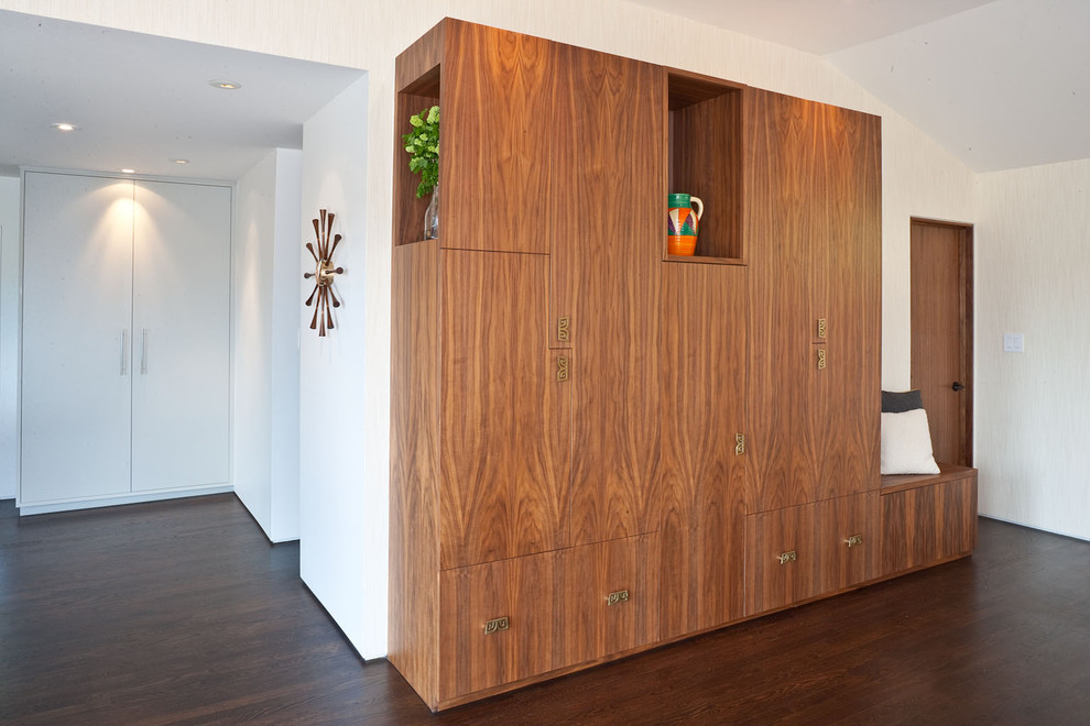 This is an example of a midcentury entryway in San Francisco with white walls and dark hardwood floors.