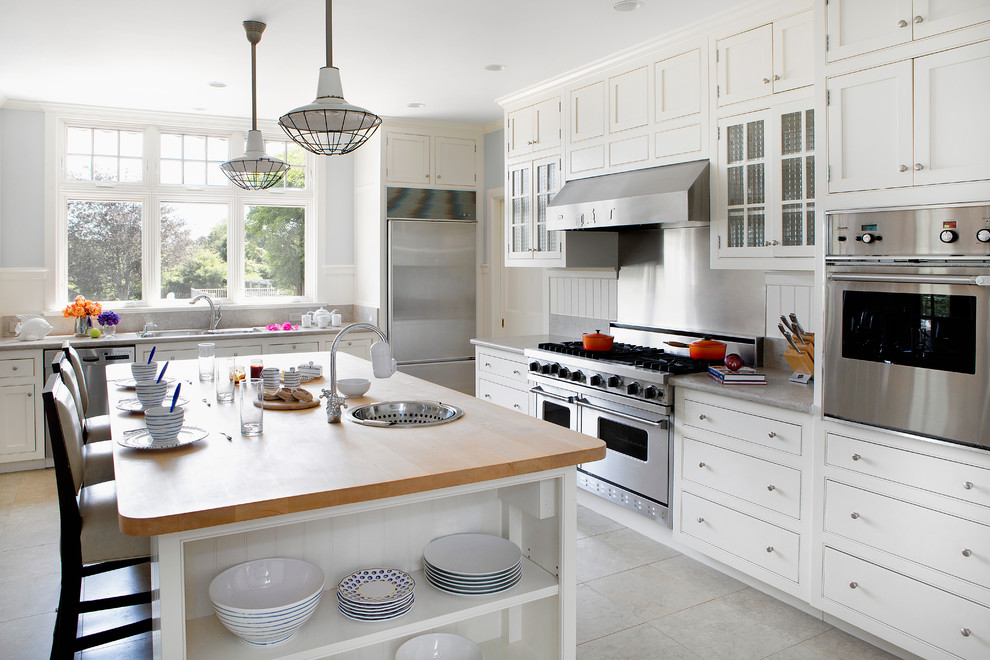 Inspiration for a timeless l-shaped kitchen remodel in New York with beaded inset cabinets, white cabinets, metallic backsplash and an island