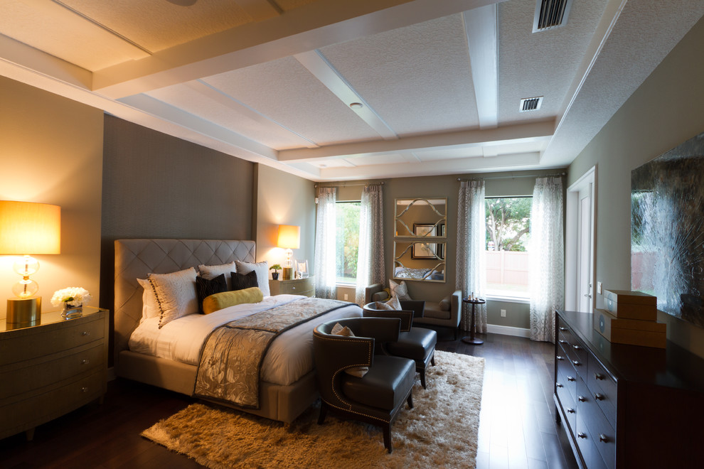 This is an example of a large mediterranean master bedroom in Orlando with brown walls, dark hardwood floors and no fireplace.
