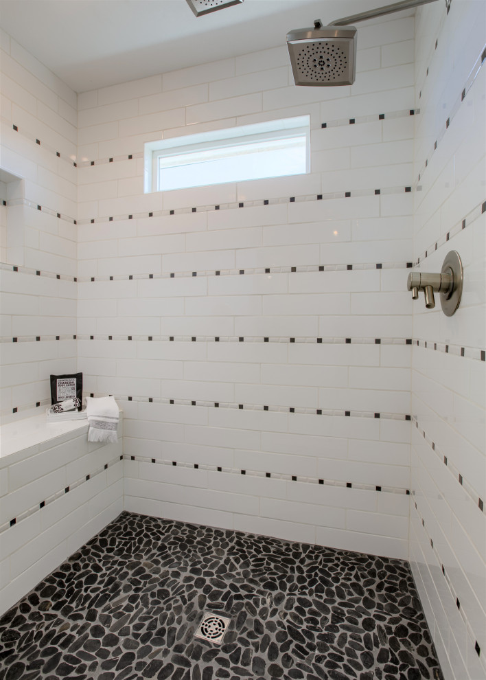 Photo of a large country master bathroom in Kansas City with shaker cabinets, white cabinets, a freestanding tub, a double shower, a one-piece toilet, black and white tile, mosaic tile, white walls, porcelain floors, a pedestal sink, granite benchtops, white floor, a hinged shower door and black benchtops.
