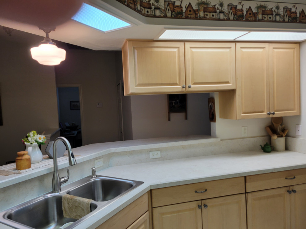 Kitchen - kitchen idea with raised-panel cabinets, light wood cabinets, laminate countertops and beige countertops