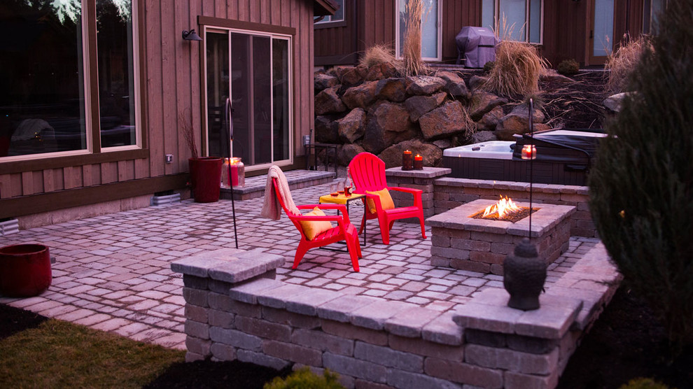 Example of a large trendy backyard concrete paver patio design with a fire pit and no cover