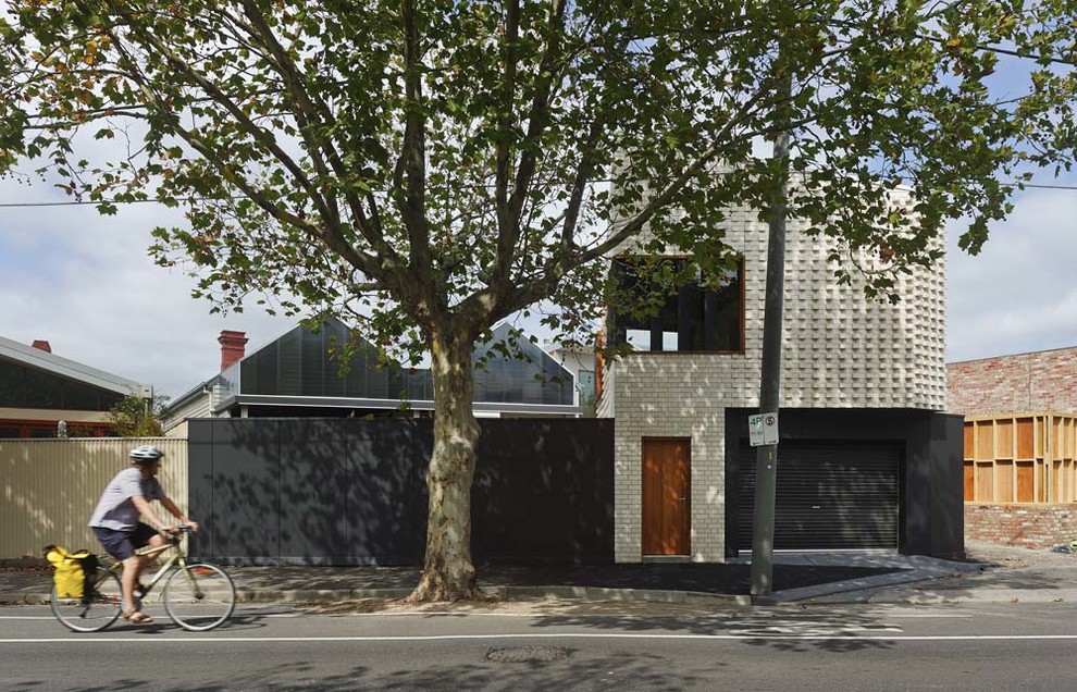 Inspiration for a small contemporary two-storey brick white exterior in Melbourne with a flat roof.