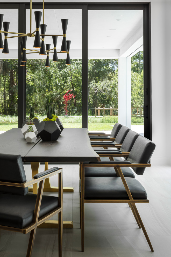 Photo of a contemporary dining room in Orlando with white walls and grey floor.